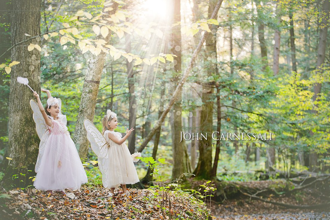 Magical looking family photo of two girls in woods with Fairy dust