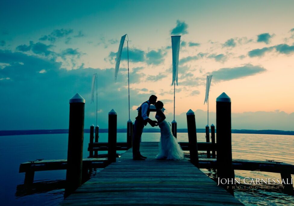Bride and groom sunset portraits by the water at the Inns of Aurora on Cayuga Lake in Aurora NY.