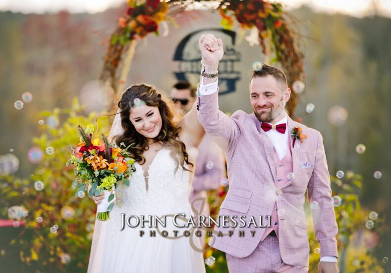 Bride and groom celebrating after just getting married at Owera Vineyards in Upstate NY
