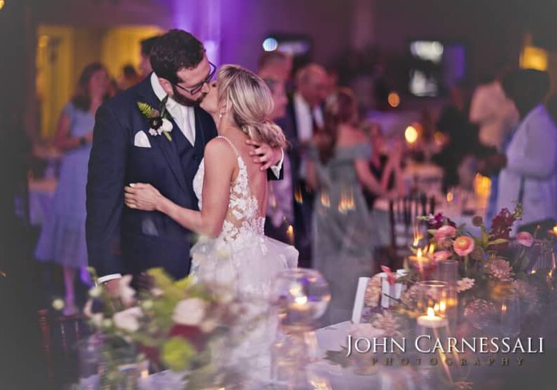 A couple shares a romantic dance at their wedding reception.