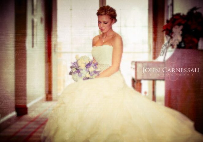 Bride holding her bouquet in a full-length portrait