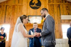 Wedding PHotography Wide shot of indoor barn ceremony setup at Wolf Oak Acres in Oneida NY