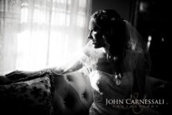 Wedding PHotography Black and white Bride sitting by a window in soft light during getting ready at Wolf Oak Acres Oneida NY