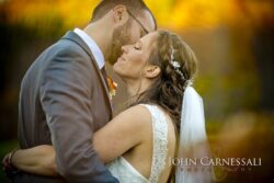 outdoor ceremony + barn reception (Wolf Oak Acres) Bride and groom kissing by the pond at Wolf Oak Acres Oneida NY with soft background