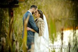 Central New York barn wedding venue Bride and groom kissing close-up in golden light at Wolf Oak Acres Oneida NY