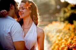 engagement photo of woman smiling in golden hour light, candid couples session portrait
