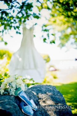 Wedding dress, shoes, and bouquet outdoors.
