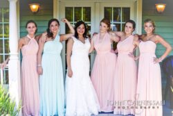 Bride with bridesmaids in pastel dresses.