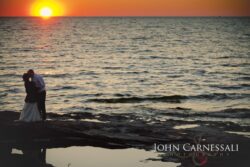 Bride and groom walking away along the shoreline at Bayshore Grove in Oswego NY