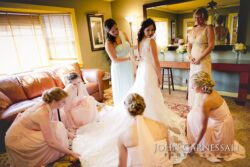 Bride and bridesmaids laughing during getting ready at Bayshore Grove in Oswego NY, Oswego wedding photography