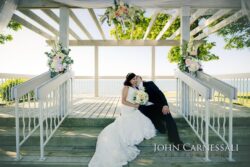 Bride and groom formal portrait near venue architecture at Bayshore Grove in Oswego NY