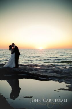 Bride and groom close-up portrait by the water at Bayshore Grove in Oswego NY