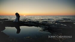 Bride and groom leaning in close by the waterfront at Bayshore Grove Oswego NY