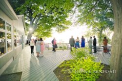 Outdoor gathering on a sunlit wooden deck.