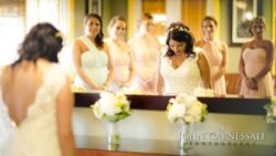 Bride with bridesmaids doing final touches before ceremony at Bayshore Grove Oswego NY