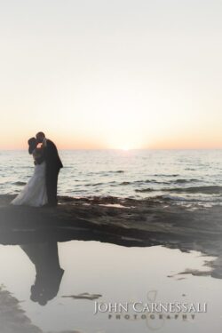 Bride and groom kissing by the water at Bayshore Grove Oswego NY, Oswego wedding photographer
