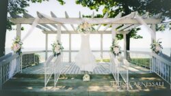 Bridal dress displayed on decorated waterfront arbor