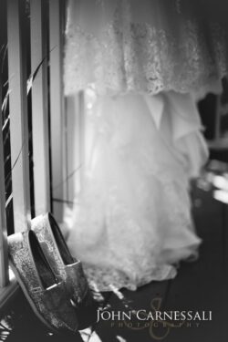 Wedding dress and shoes in soft focus.