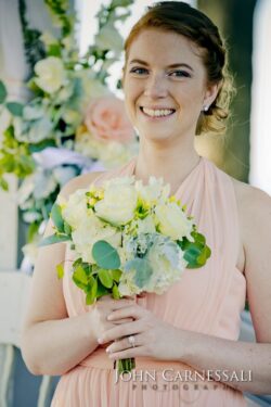 Smiling woman holding a bouquet of flowers.