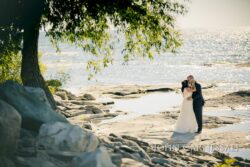 Bride and groom formal portrait by the water at Bayshore Grove in Oswego NY, Oswego wedding photography