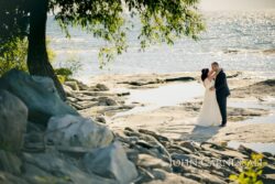 Bride and groom walking by the water at Bayshore Grove in Oswego NY, Oswego NY wedding photography
