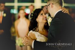 Bride smiling up at groom during dance