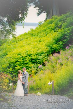 Wedding couple walking across the lawn at Belhurst Castle Geneva NY, Seneca Lake Finger Lakes wedding venue