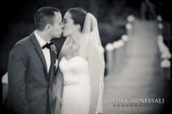 Black and white wedding kiss on dock