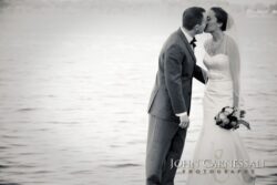 Bride and groom walking along the lakeshore at Belhurst Castle Geneva NY, Seneca Lake wedding photos