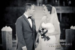 Bride and groom kissing by the water at Belhurst Castle Geneva NY, Seneca Lake wedding day