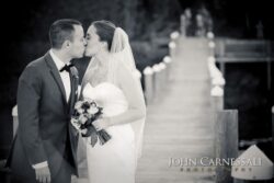 Bride and groom portrait with Seneca Lake in the background at Belhurst Castle Geneva NY, Finger Lakes wedding