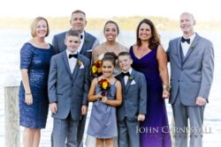 Group portrait by a lake, formal attire.
