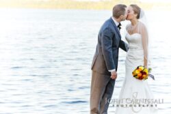 Wedding couple by the water at Belhurst Castle in Geneva NY on Seneca Lake, Finger Lakes wedding day portraits