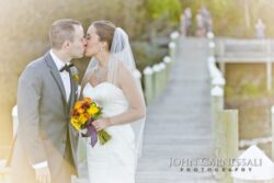 Wedding couple sunset portraits by the water at Belhurst Castle in Geneva NY, Seneca Lake golden hour