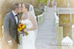 Wedding couple by the water at Belhurst Castle in Geneva NY on their wedding day, Seneca Lake