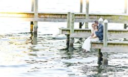 Bride and groom portrait in soft evening light by the water at Belhurst Castle Geneva NY, Seneca Lake