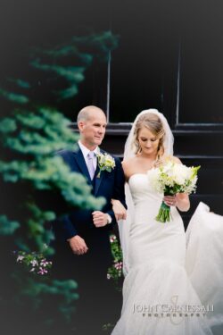 Bride walking down the aisle during the ceremony at Belhurst Castle Geneva NY