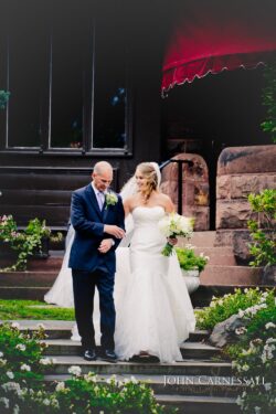 Father walking the bride down the aisle during the wedding ceremony at Belhurst Castle in Geneva NY, Finger Lakes