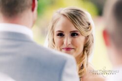 Bride smiling during wedding ceremony.