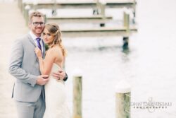 Bride and groom hugging in soft evening light by the water at Belhurst Castle Geneva NY, Seneca Lake portraits
