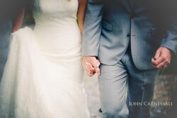 Wedding couple hugging by the water at Belhurst Castle in Geneva NY, Seneca Lake Finger Lakes wedding portraits
