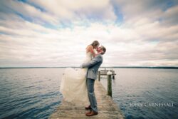 Groom picking up the bride at sunset by the water at Belhurst Castle in Geneva NY, Seneca Lake wedding portraits