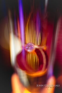 Engagement ring sparkling amid vertical light streaks
