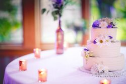 Wedding cake with floral decorations on table.