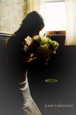 bride putting on wedding dress at Belhurst Castle in Geneva NY, Finger Lakes wedding day