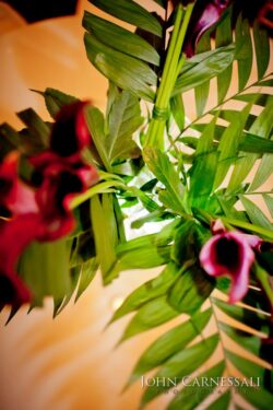 Purple flowers and green leaves in bouquet.
