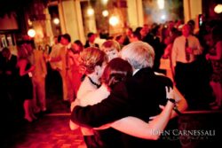 People hugging on a dance floor, party.