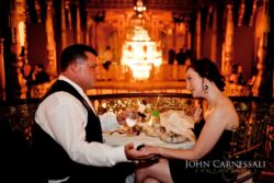 Couple dining elegantly in ornate setting.