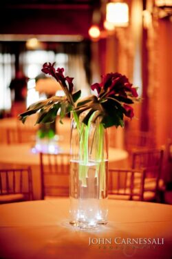 Vase with flowers on a decorated table.