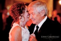Elderly man and woman dancing and laughing.